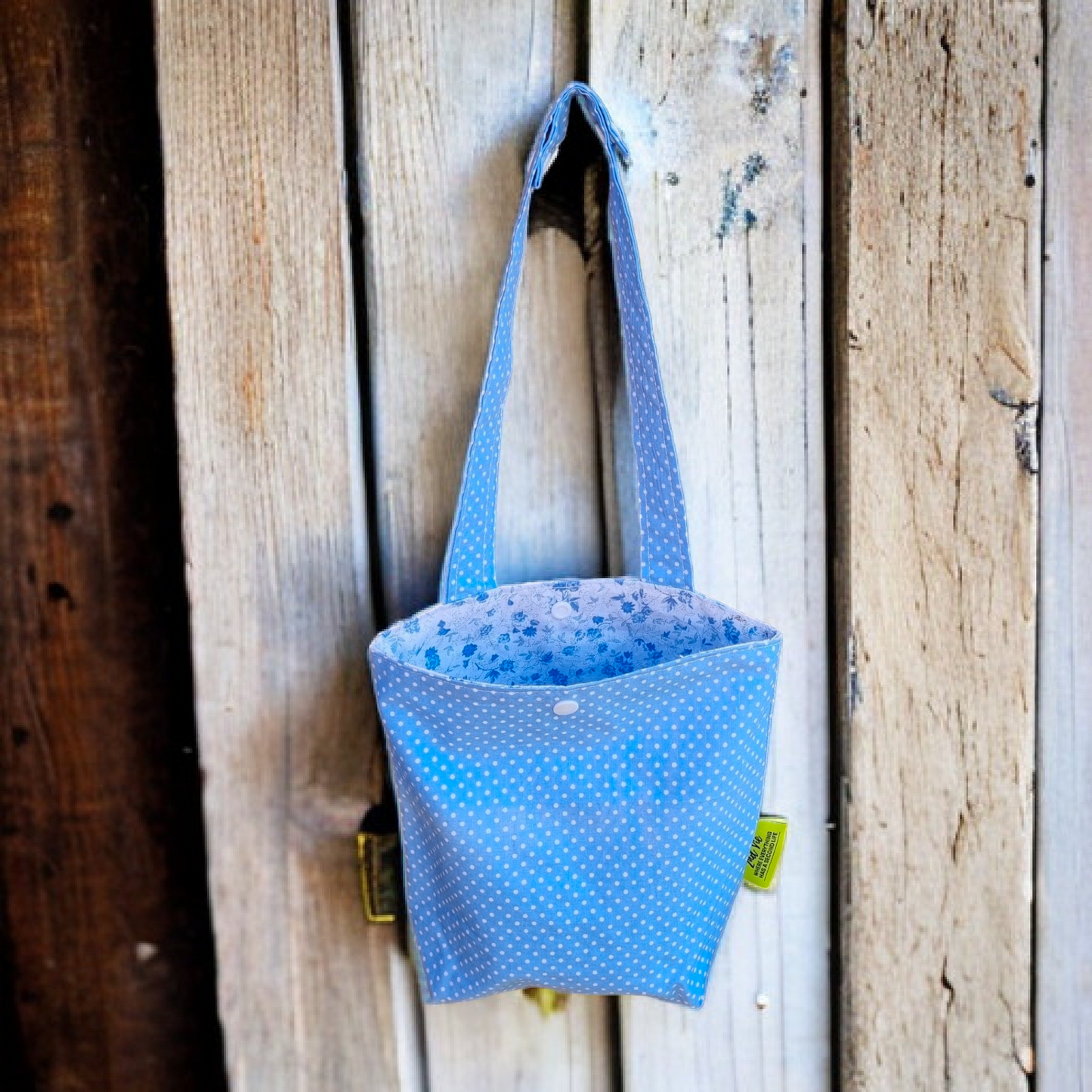 Car & Home Tidy Bag light blue background with small white dots. inside fabric has small blue flowers
