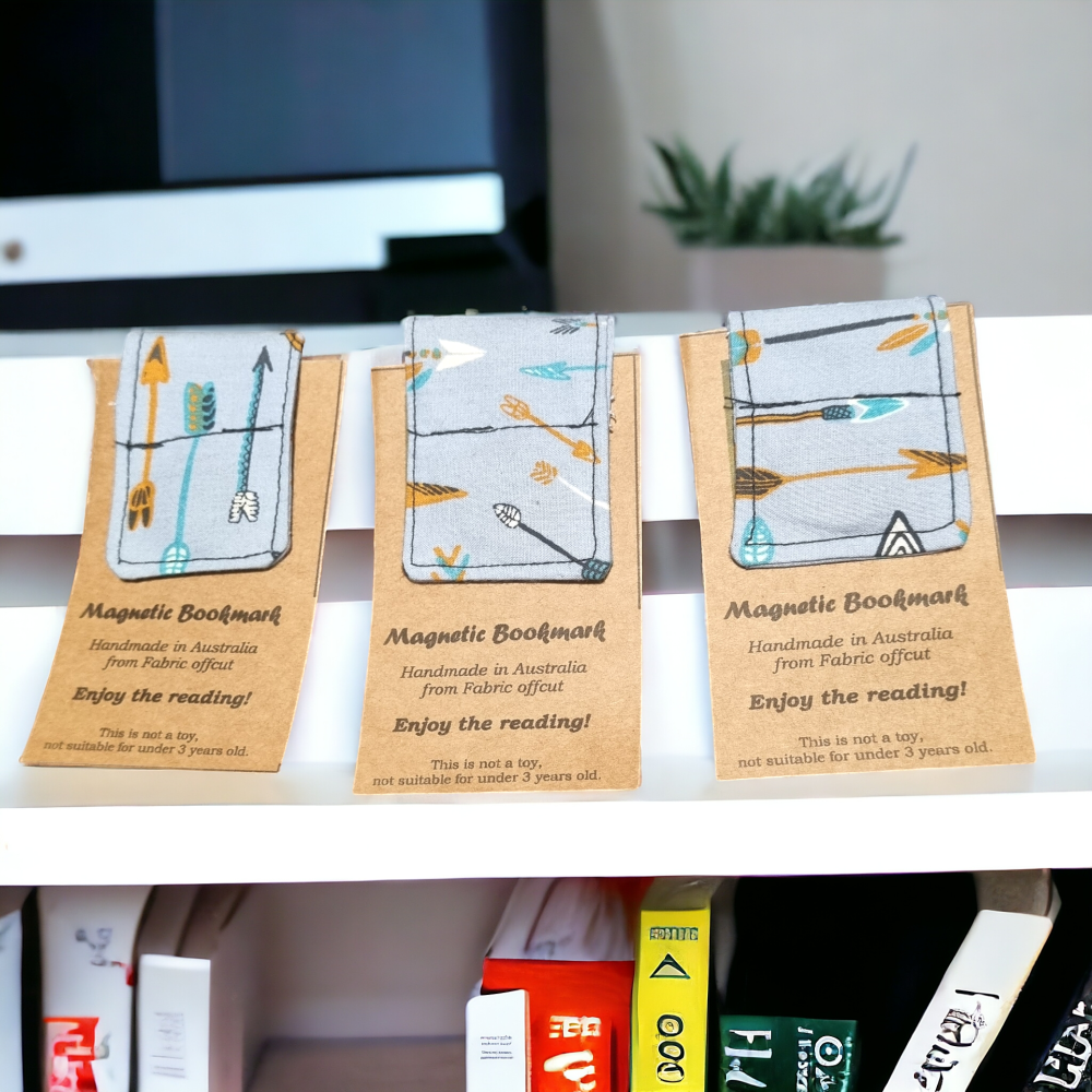 Light Blue magnetic bookmark with orange arrow on it