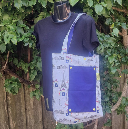 Handmade tote bag featuring Eiffel Tower illustration pattern and royal blue pocket.