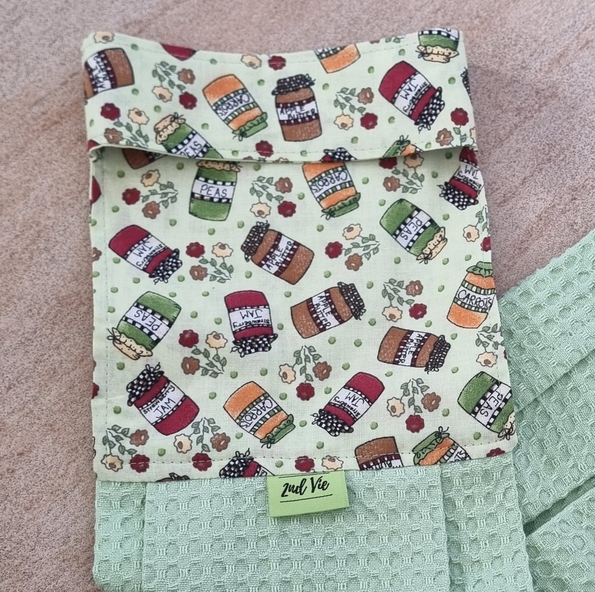 Close-up of pantry jar print on a mint green waffle hanging tea towel