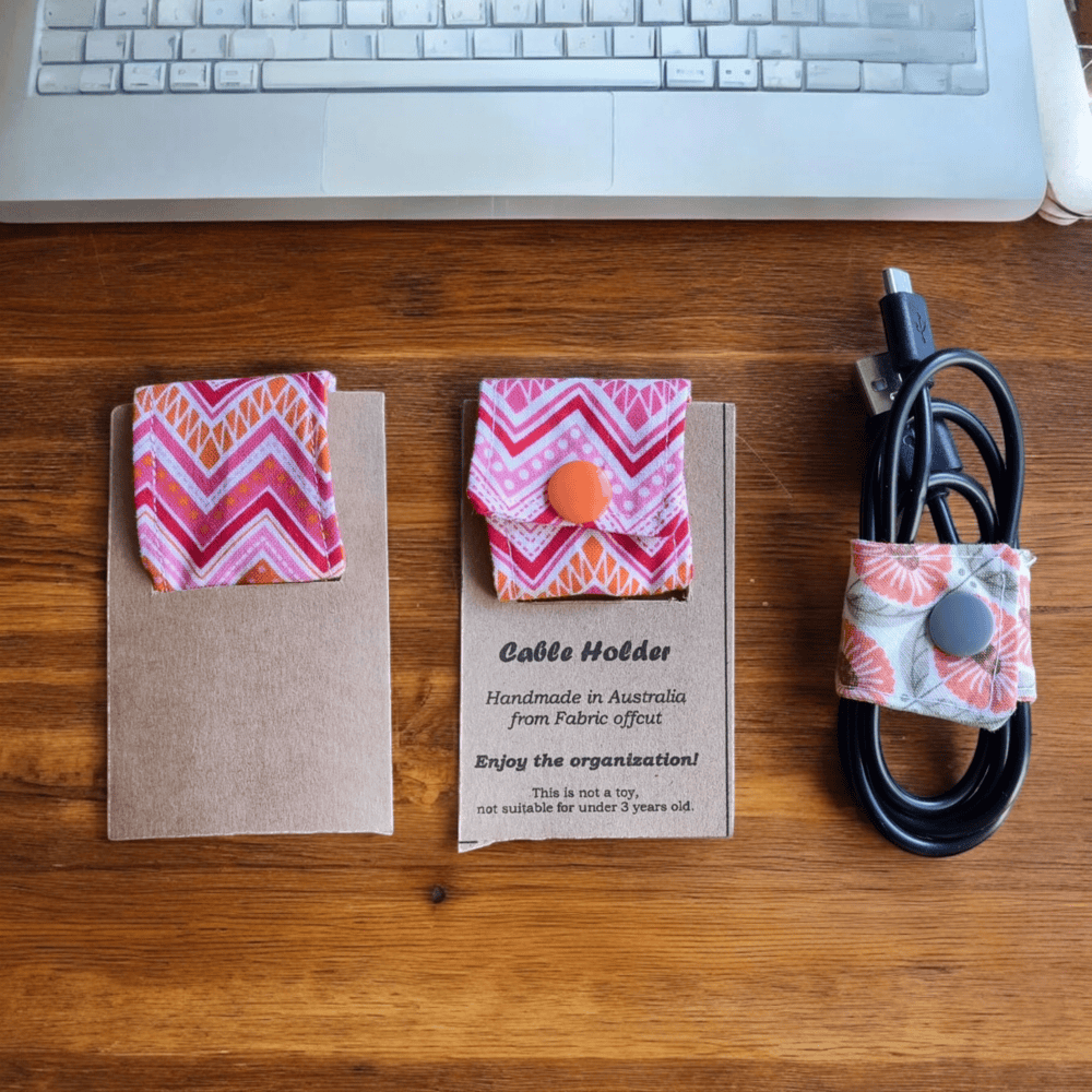 Pink Lines Cable Holder Organiser holding USB cables on desk
