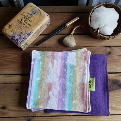 Reusable makeup remover pads with pastel watercolour pattern in purple, pink, and teal colours, displayed with lavender soap and cotton