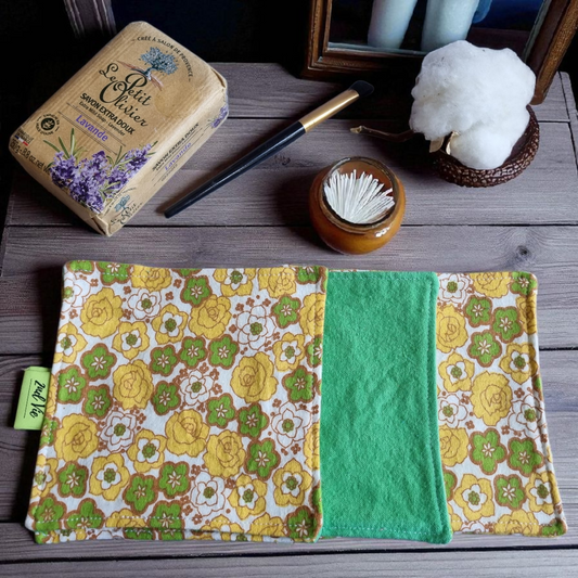 Sustainable makeup remover pads with retro yellow and green floral design, photographed with artisan soap and cotton flower
