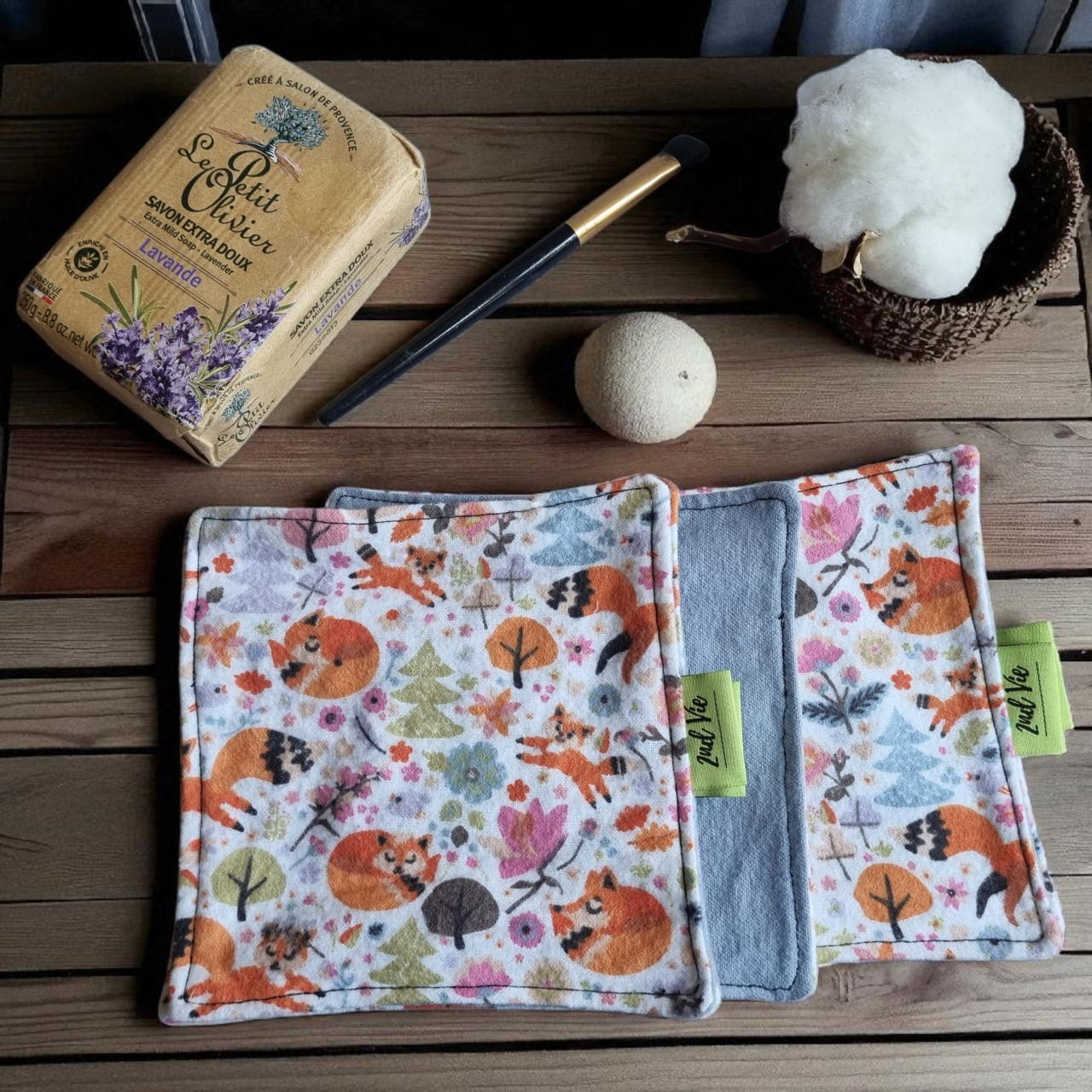 Eco-friendly makeup remover pads featuring cute woodland animals including foxes and raccoons, styled with natural soap and cotton