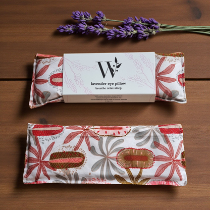 Banksia patterned lavender eye pillow with packaging on a wooden surface