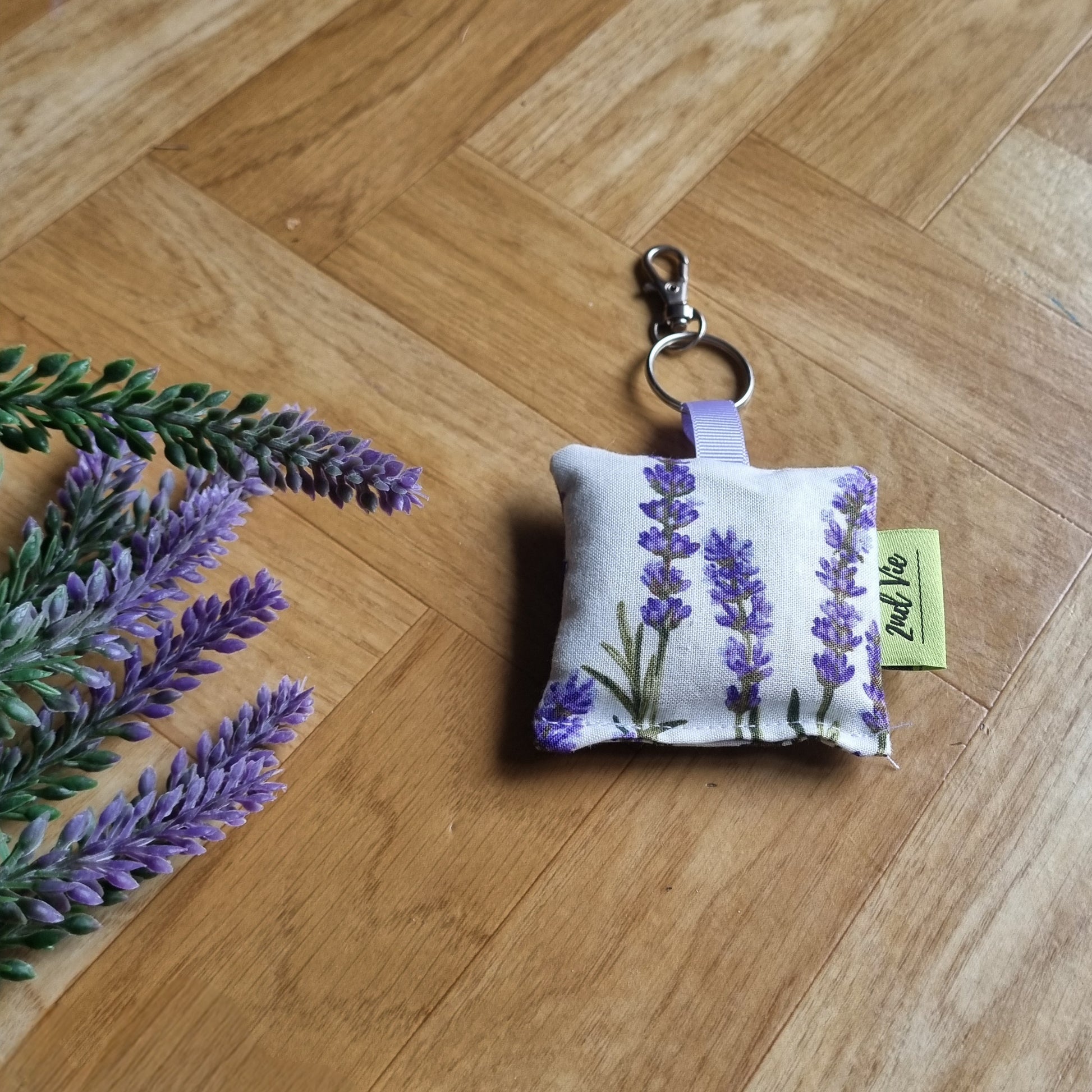 Keychain with lavender design on a wooden surface